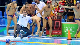 Serbiens Wasserball-Team um Trainer Dejan Savic (3. v. l.) jubelt über seinen Sieg. © dpa - Bildfunk Foto: Orestis Panagiotou